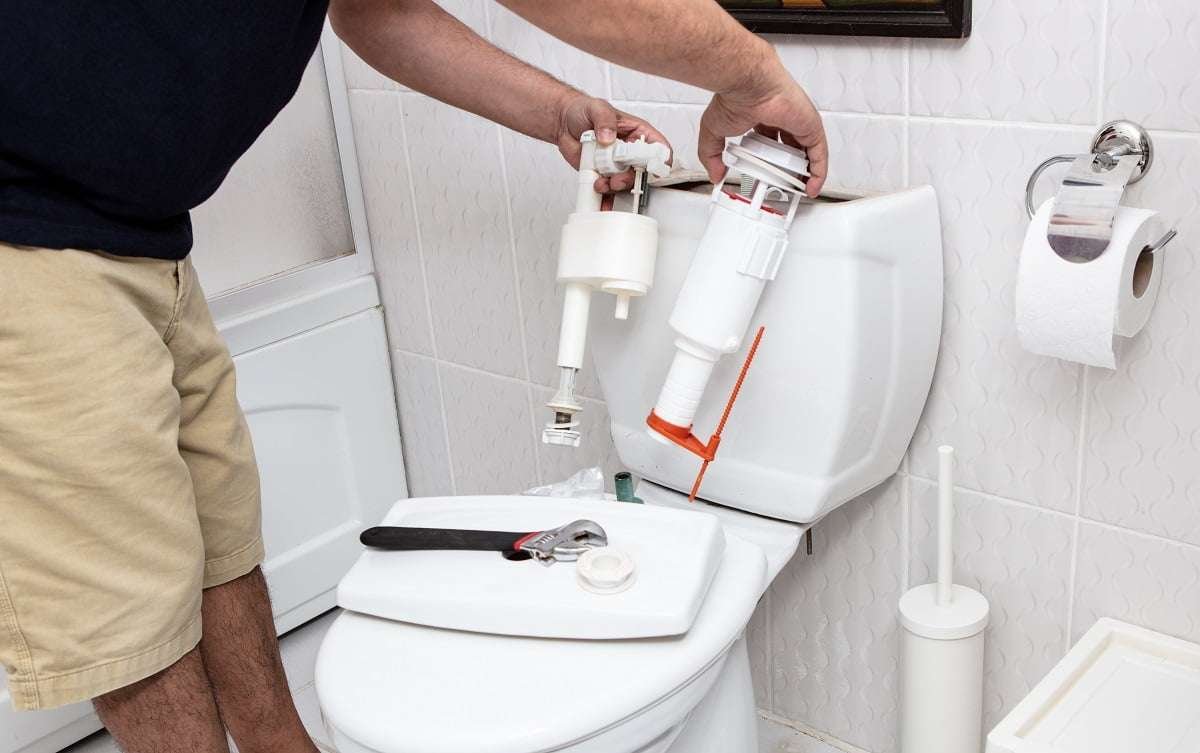 Man using tools repairing reservoir