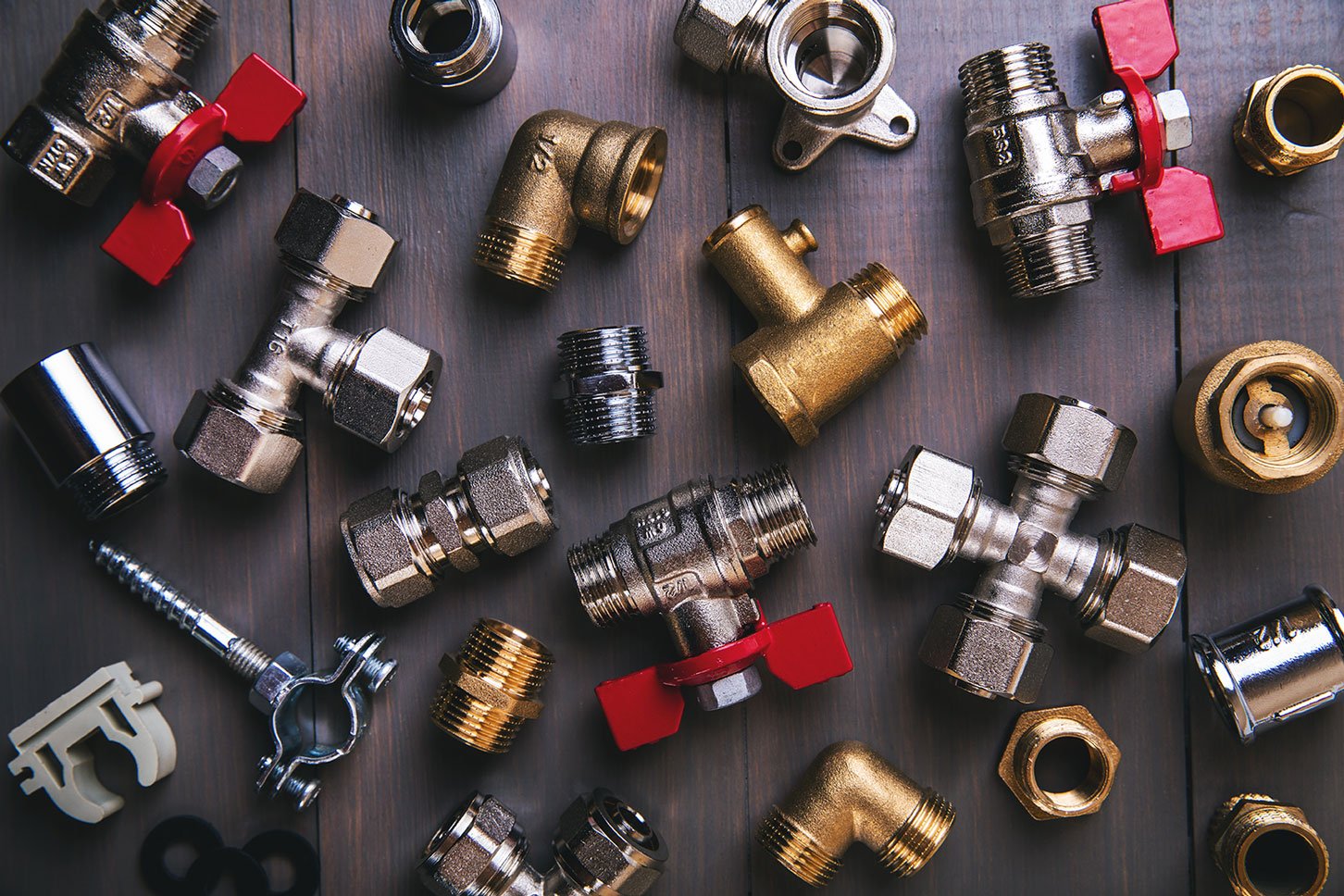 group of plumbing fittings and equipment on wooden background