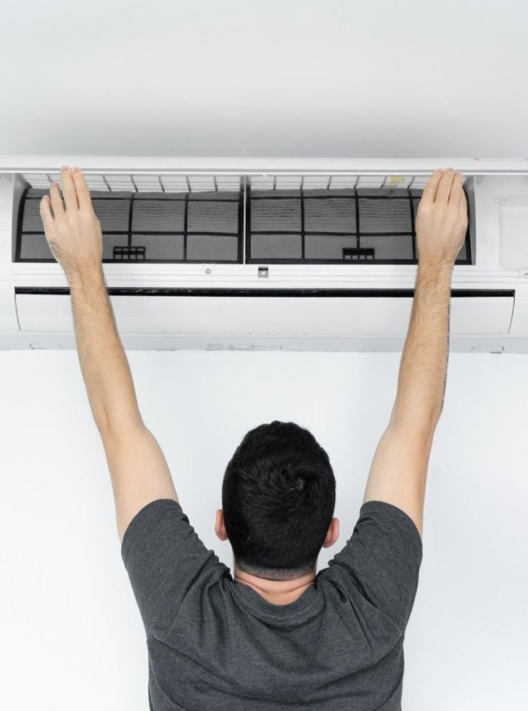 guy-cleans-filter-home-air-conditioner-from-dust
