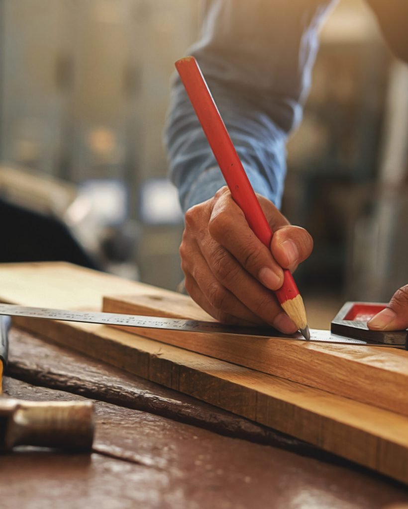 Carpenter working on woodworking machines in carpentry shop. woman works in a carpentry shop.