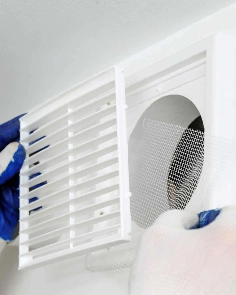 worker-installs-ventilation-grille